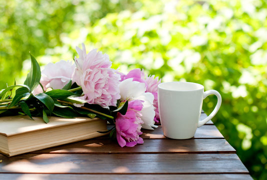 An open weekly planner notebook on a wooden table surrounded by fresh seasonal vegetables and a warm cup of tea